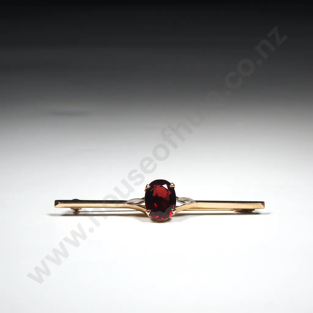 9ct Gold Bar Brooch Set With A Facetted Oval Garnet Image 1++