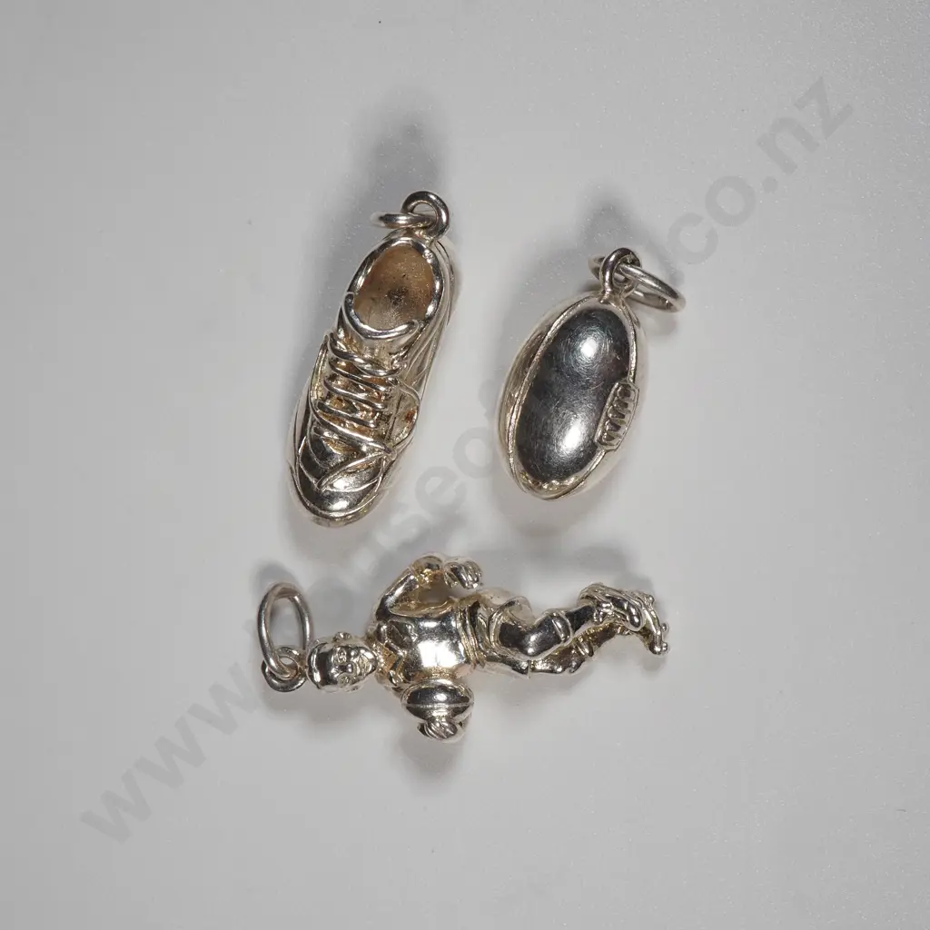 Three Sterling Silver Rugby Charms Including A Rugby Ball, Rugby Player & A Rugby Boot Image 1++