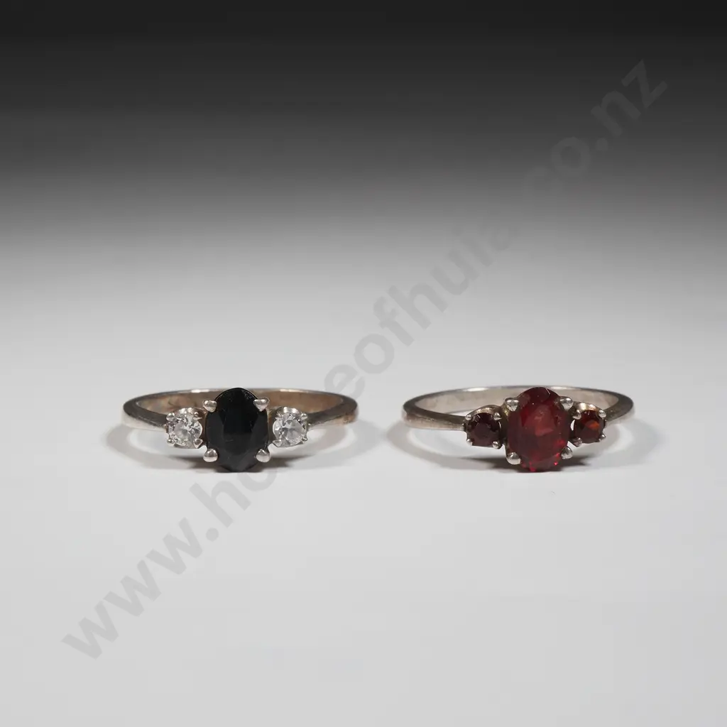 Two Sterling Silver Rings: One with Blue Stone Flanked By White Stones, The Other With Three Red Stones Image 1++