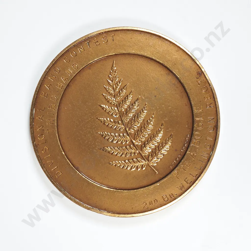 Bronze medal “NEW ZEALAND DIVISION / BRITISH EXPEDITIONARY FORCE”, engraved “DIVISIONAL BAND CONTEST / THIRD BAND / PTE. A. BOGLE / 2ND BN WELLINGTON REGT”, C.1917. 45mm. It is listed in the Medallic Commemoratives of New Zealand 1865-1940 by Leon Morel as number B/1 Image 1++