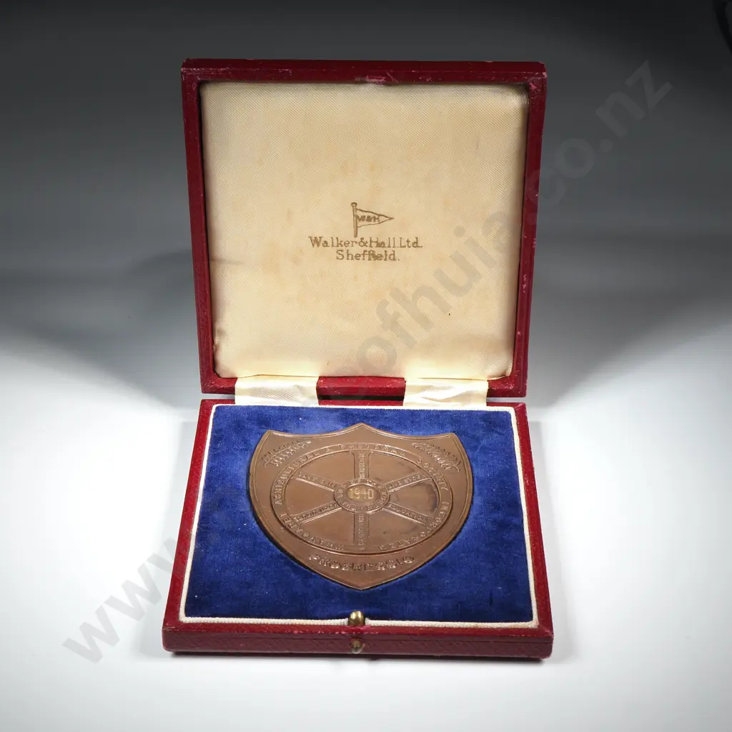 Cased copper prize fob medal, on the front “WHANGAREI AGRICULTURAL & PASTORAL SOCIETY INCORPORATED”, “PROGRESSIO” and “THE HUB OF THE NORTH”, engraved 1940,  the back engraved “MASTER BAKERS / L. FORD”, 76mm x 63mm Image 1++
