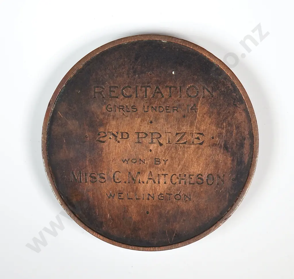 Antique copper medal “NEW ZEALAND COMPETITIONS SOCIETY / WELLINGTON FESTIVAL / 1912”, engraved “RECITATION / GIRLS UNDER 14 / 2ND PRIZE / WON BY / MISS C. M. AITCHESON / WELLINGTON”, 38mm Image 1++