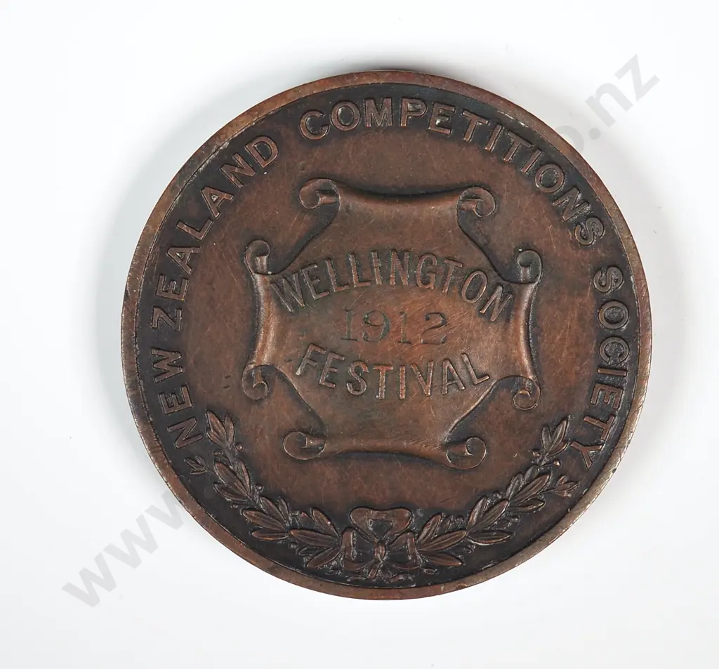 Antique copper medal “NEW ZEALAND COMPETITIONS SOCIETY / WELLINGTON FESTIVAL / 1912”, engraved “RECITATION / GIRLS UNDER 14 / 2ND PRIZE / WON BY / MISS C. M. AITCHESON / WELLINGTON”, 38mm Image 1++
