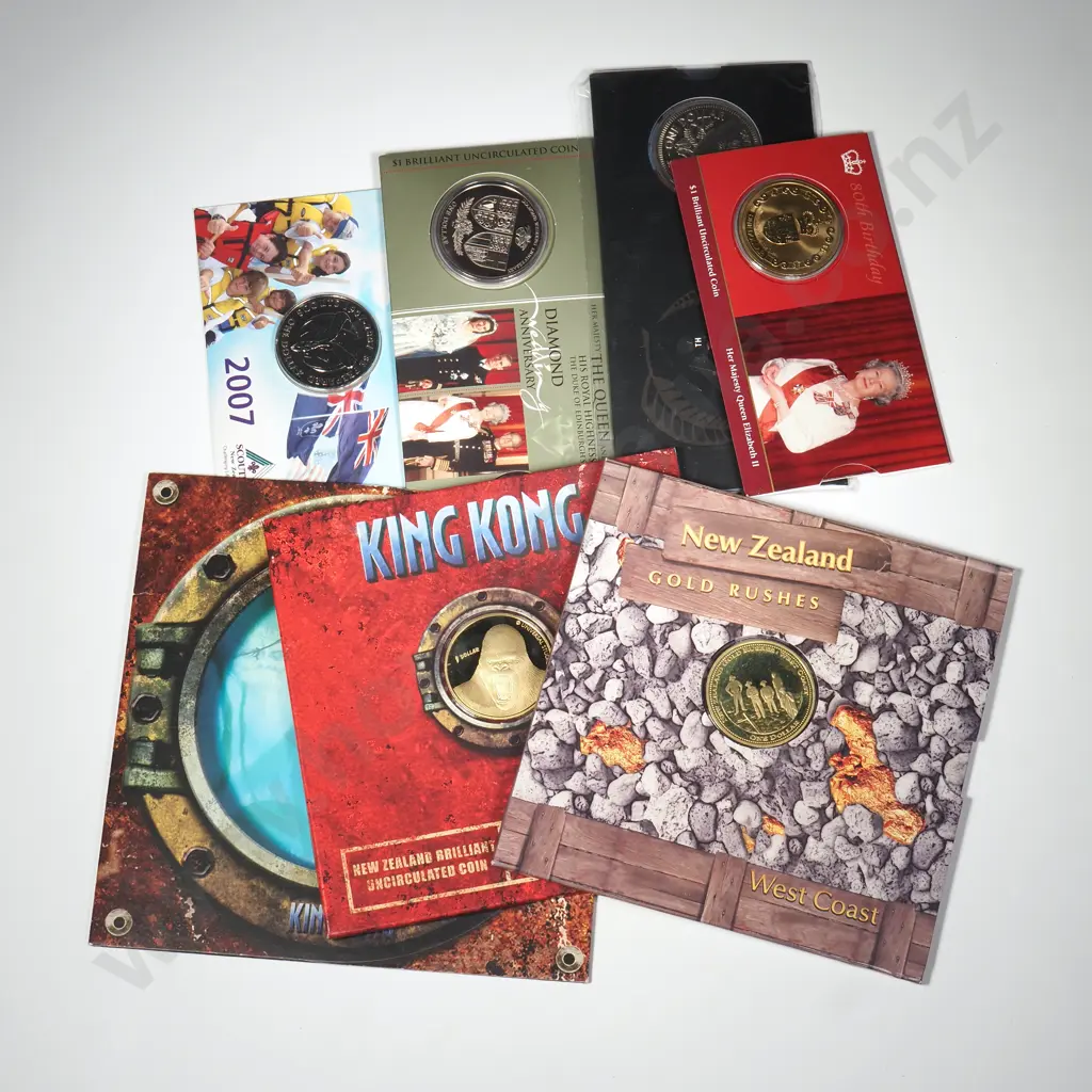 9 X UNC $1 COINS IN ORIGINAL PACKAGING – 2005 KING KONG SINGLE, 2005 KING KONG SET OF 3, 2006 QEII 80TH BIRTHDAY, 2006 NZ GOLD RUSHES, 2007 SCOUTING, 2007 DIAMOND WEDDING ANNIVERSAREY, 2009 RESERVE BANK C.C.V. $245 Image 1++