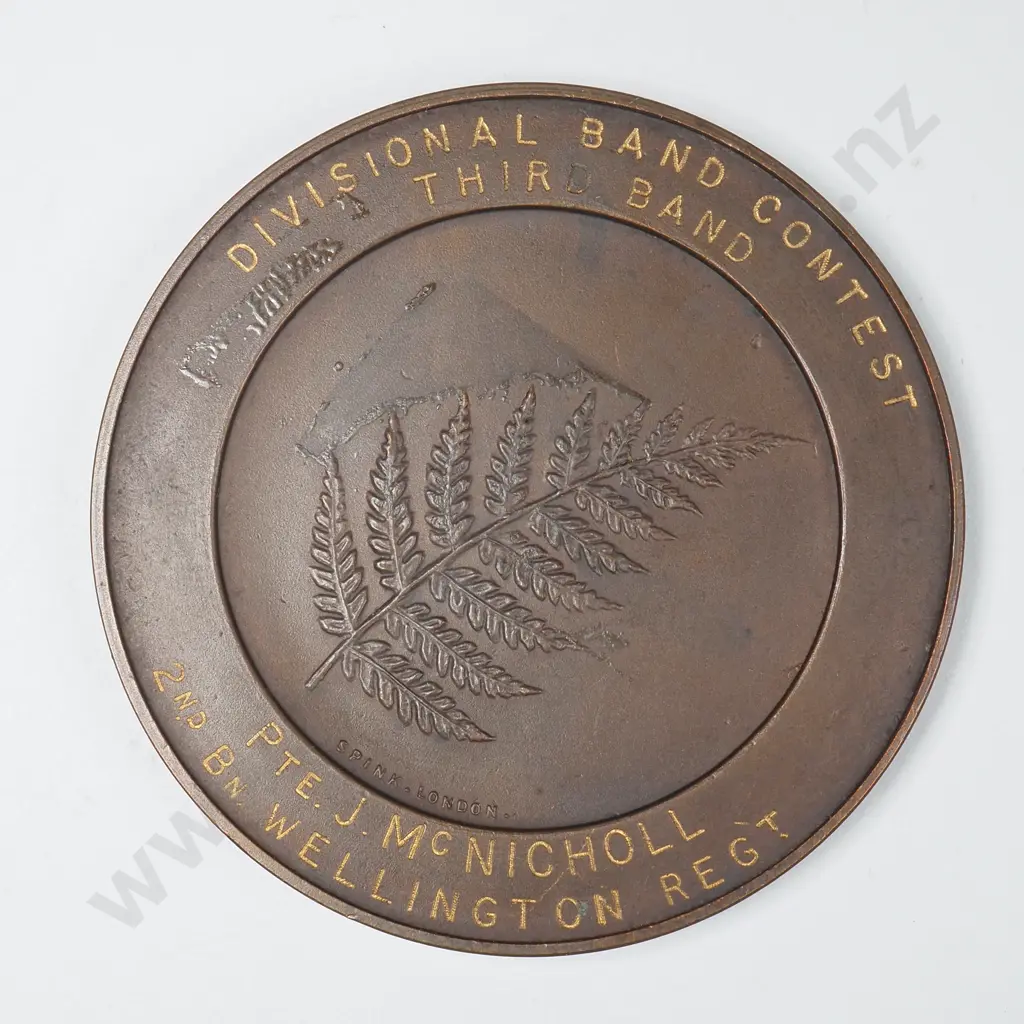 Bronze medal “NEW ZEALAND DIVISION / BRITISH EXPEDITIONARY FORCE”, engraved “DIVISIONAL BAND CONTEST / THIRD BAND / PTE. J. McNICHOLL / 2ND BN WELLINGTON REGT”, C.1917. 45mm. It is listed in the Medallic Commemoratives of New Zealand 1865-1940 by Leon Morel as number B/1 Image 1++