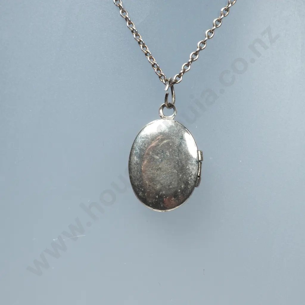 Small Oval Sterling Silver Locket & Chain & Silver Charm in the Form of a Pair of Baby's Shoes Image 1++