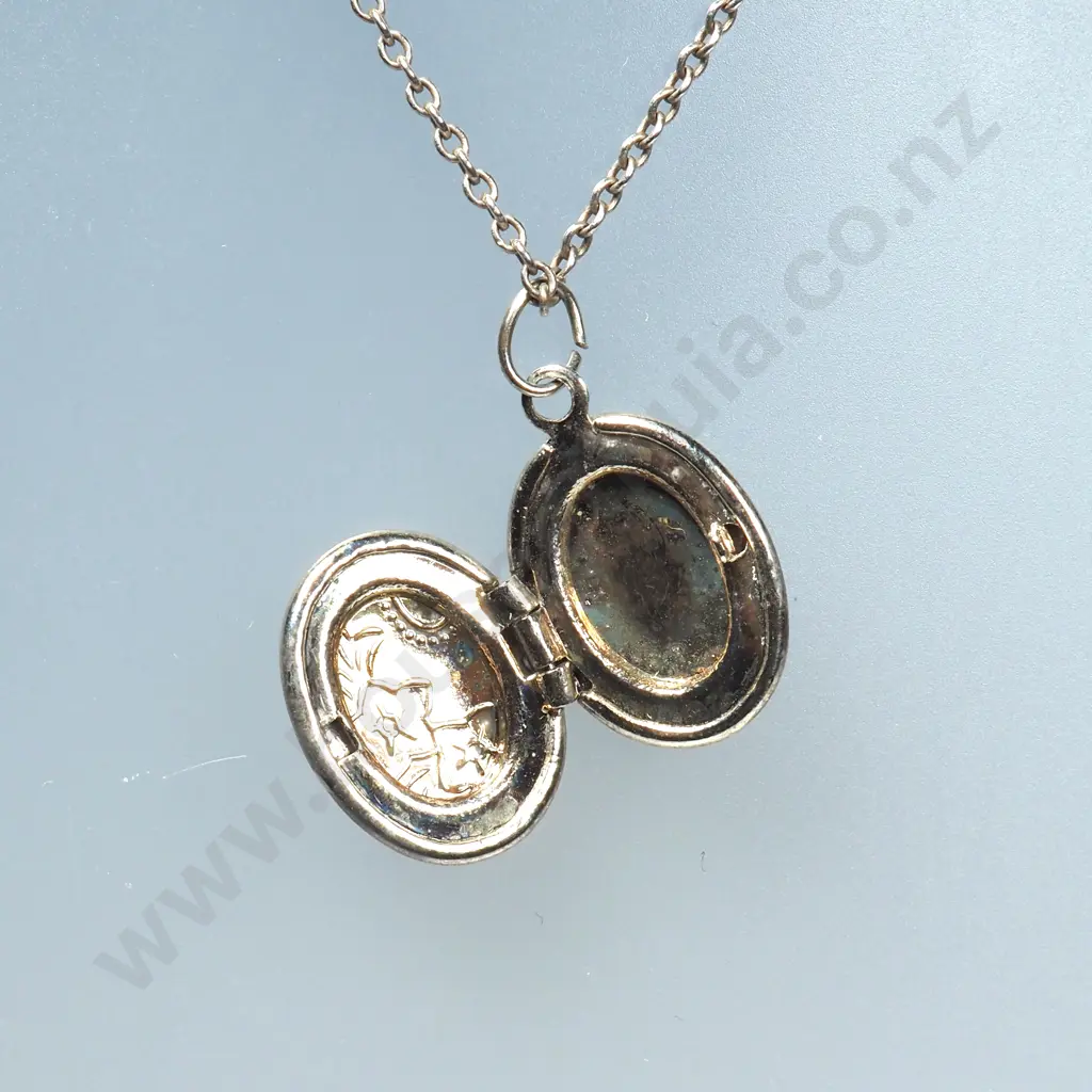 Small Oval Sterling Silver Locket & Chain & Silver Charm in the Form of a Pair of Baby's Shoes Image 1++