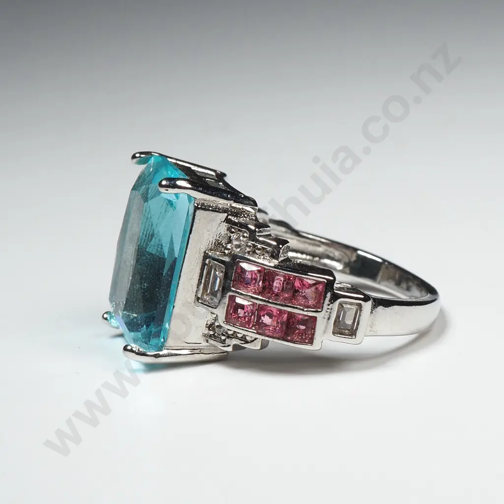 Costume Dress Ring With Large Central Aqua Coloured Stone Flanked by Red Stones Image 1++