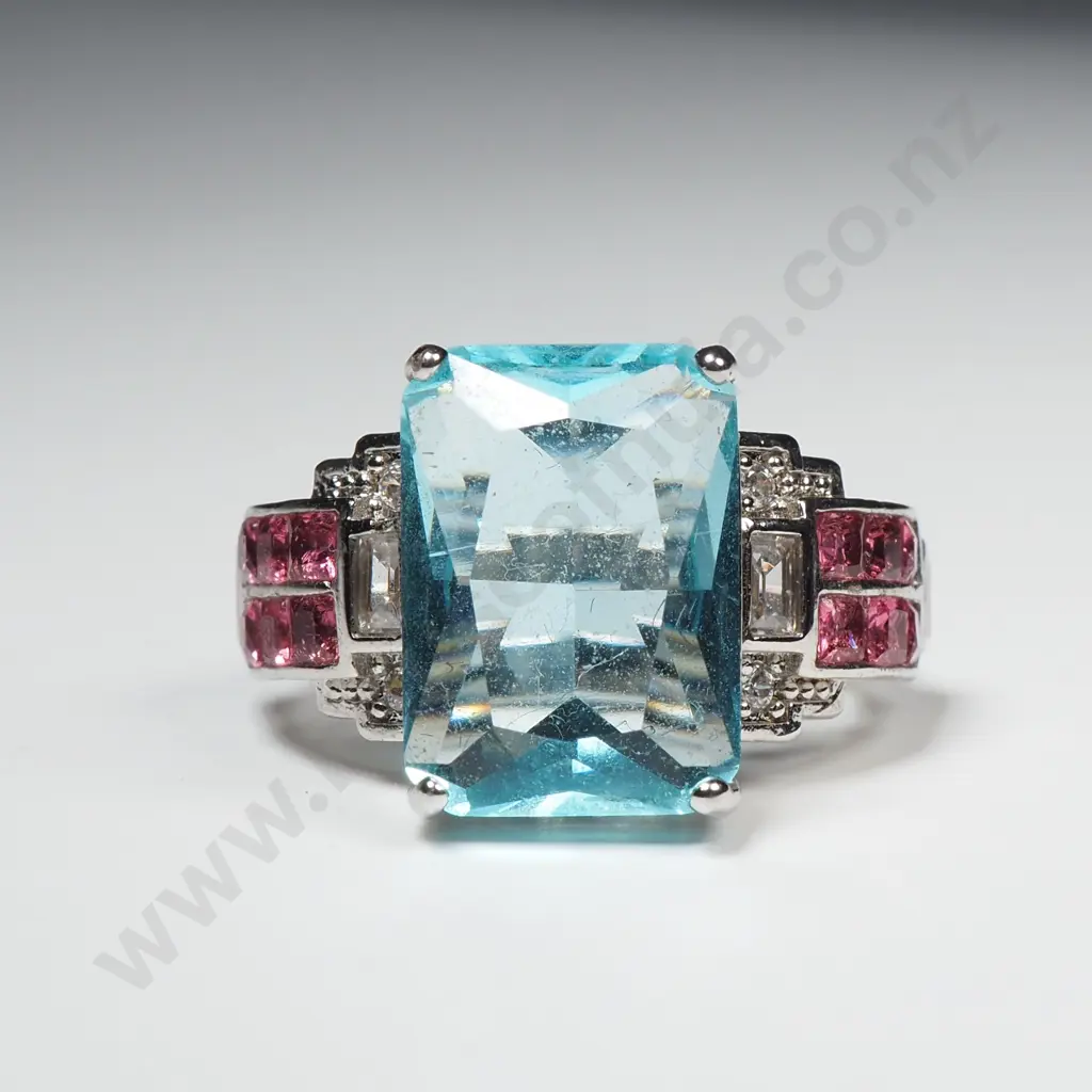 Costume Dress Ring With Large Central Aqua Coloured Stone Flanked by Red Stones Image 1++