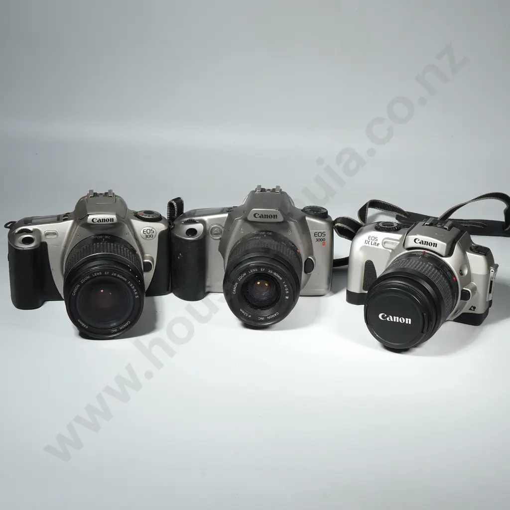 Three Canon Film Cameras: Eos IX Lite, EOS 3000, EOS 300 Image 1++