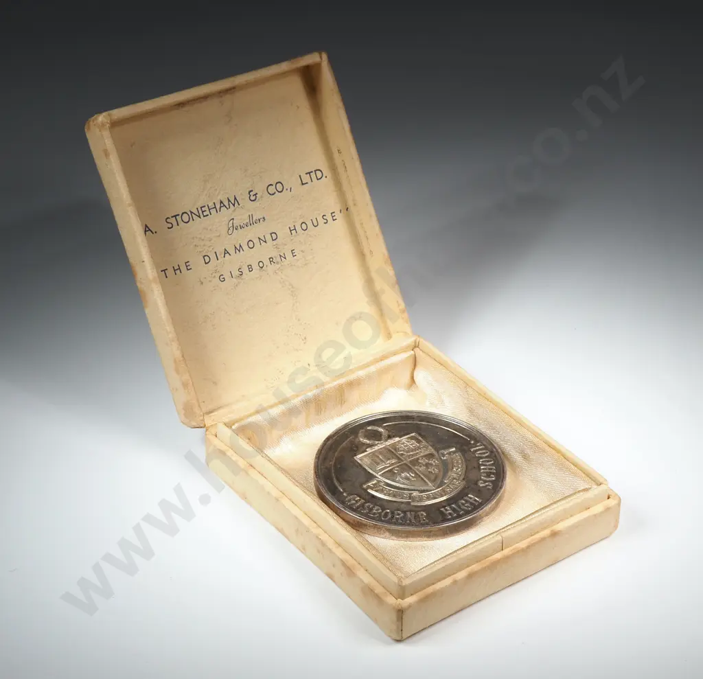 Cased sterling silver medal “GISBORNE HIGH SCHOOL”, “MERIT AWARD / PRESENTED BY PARENTS’ ASSOC.”, engraved “I. A. COOPER”, 45mm, 44.6 grams. The case reads “A. STONEHAM & CO., LTD. / JEWELLERS / THE DIAMOND HOUSE / GISBORNE” Image 1++