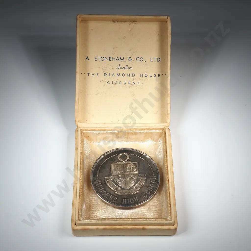 Cased sterling silver medal “GISBORNE HIGH SCHOOL”, “MERIT AWARD / PRESENTED BY PARENTS’ ASSOC.”, engraved “I. A. COOPER”, 45mm, 44.6 grams. The case reads “A. STONEHAM & CO., LTD. / JEWELLERS / THE DIAMOND HOUSE / GISBORNE” Image 1++