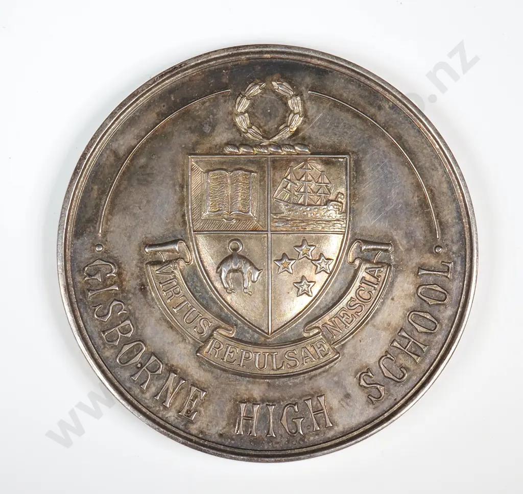 Cased sterling silver medal “GISBORNE HIGH SCHOOL”, “MERIT AWARD / PRESENTED BY PARENTS’ ASSOC.”, engraved “I. A. COOPER”, 45mm, 44.6 grams. The case reads “A. STONEHAM & CO., LTD. / JEWELLERS / THE DIAMOND HOUSE / GISBORNE” Image 1++