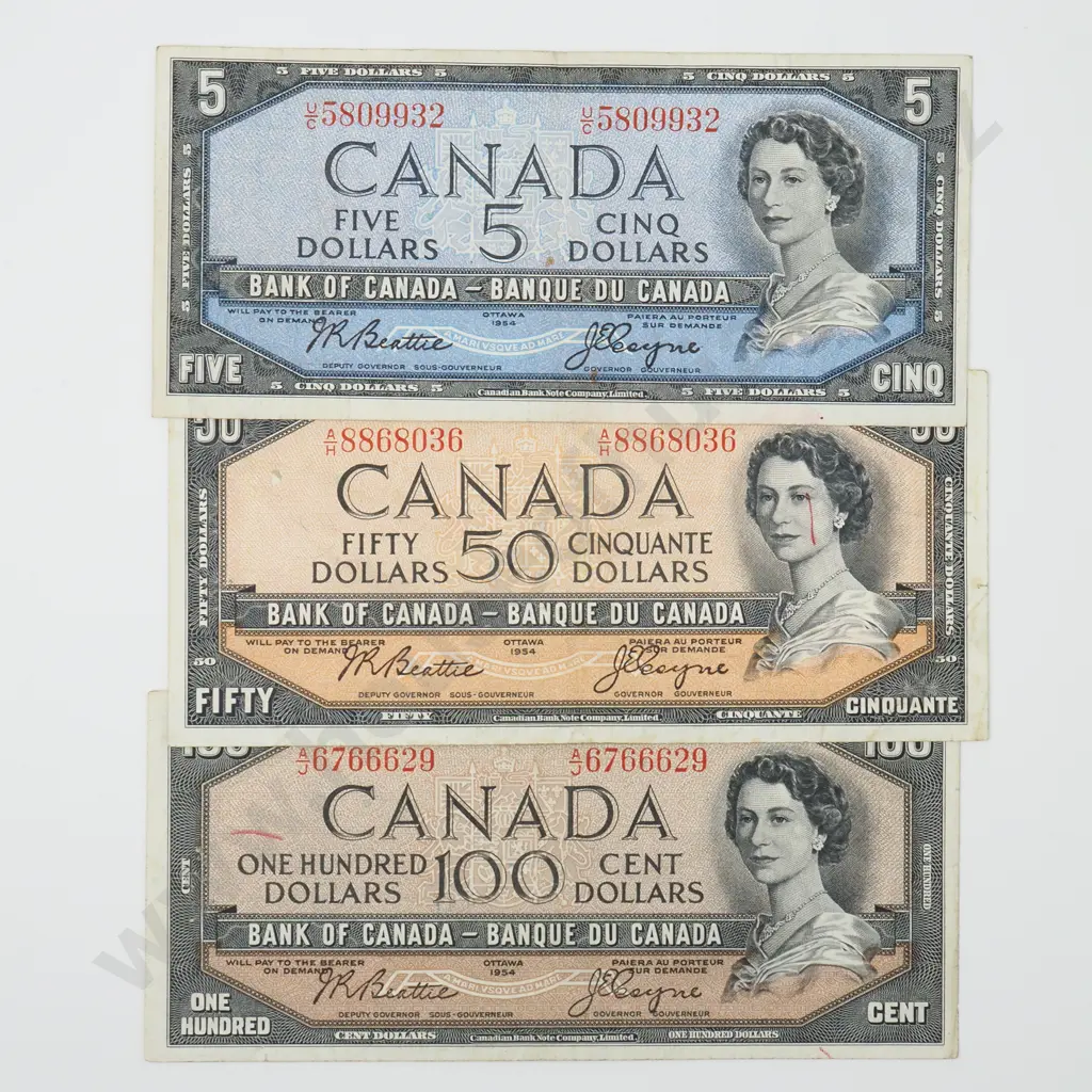 3 X CANADIAN NOTES EACH DATED 1954 – FIVE DOLLARS FINE, FIFTY DOLLARS FINE ( PEN MARK TO FACE AND 7487 TOP RIGHT CORNER ), ONE HUNDRED DOLLARS VF ( PEN MARK TO LEFT, INK TO BACK AND TINY TEAR IN BOTTOM EDGE ), APPROXIMATE EXCHANGE RATE Image 1++