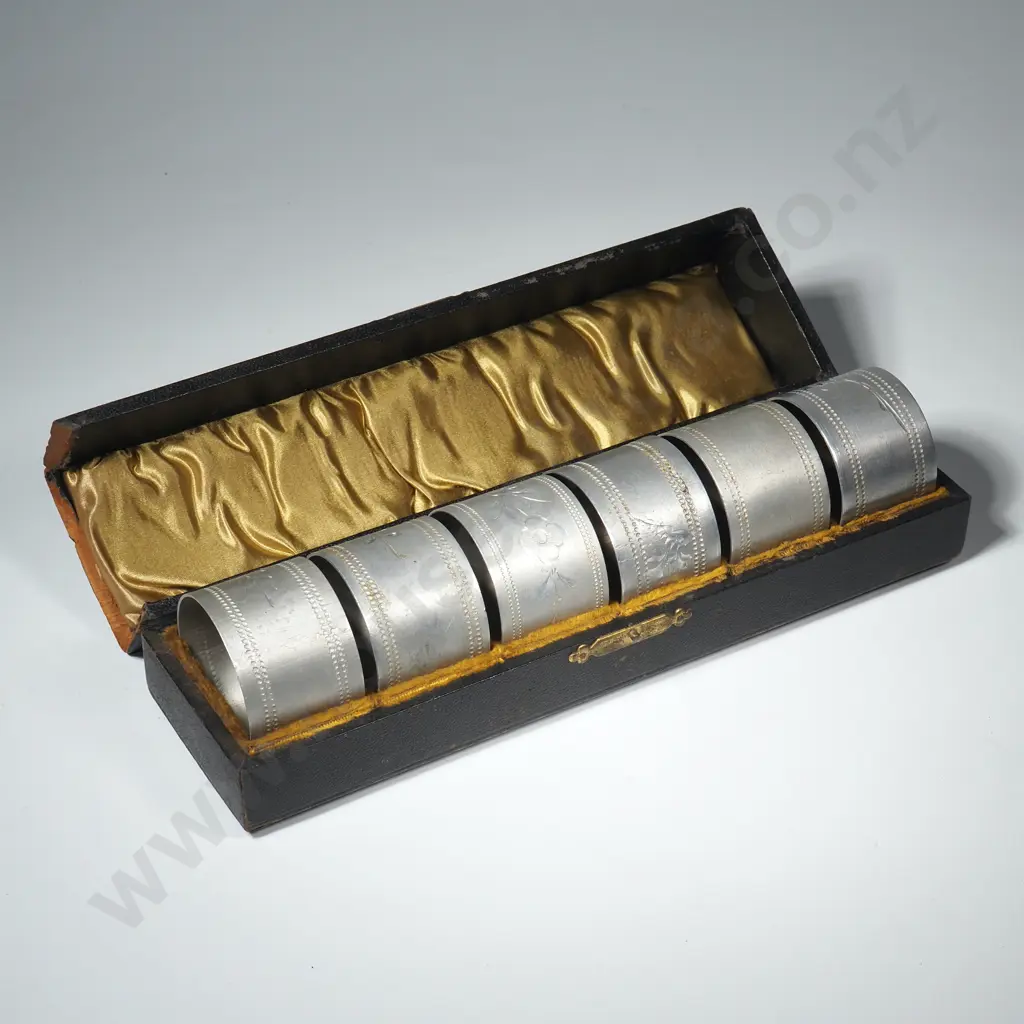 Antique Box Containing Six Later Aluminum Serviette Rings.   Image 1++