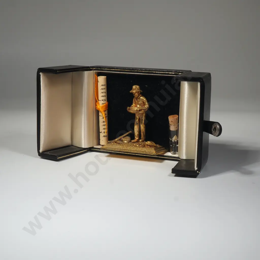 A Small Statue Of A Gold Prospector With Small Amount Of Gold In A Glass Bottle Image 1++