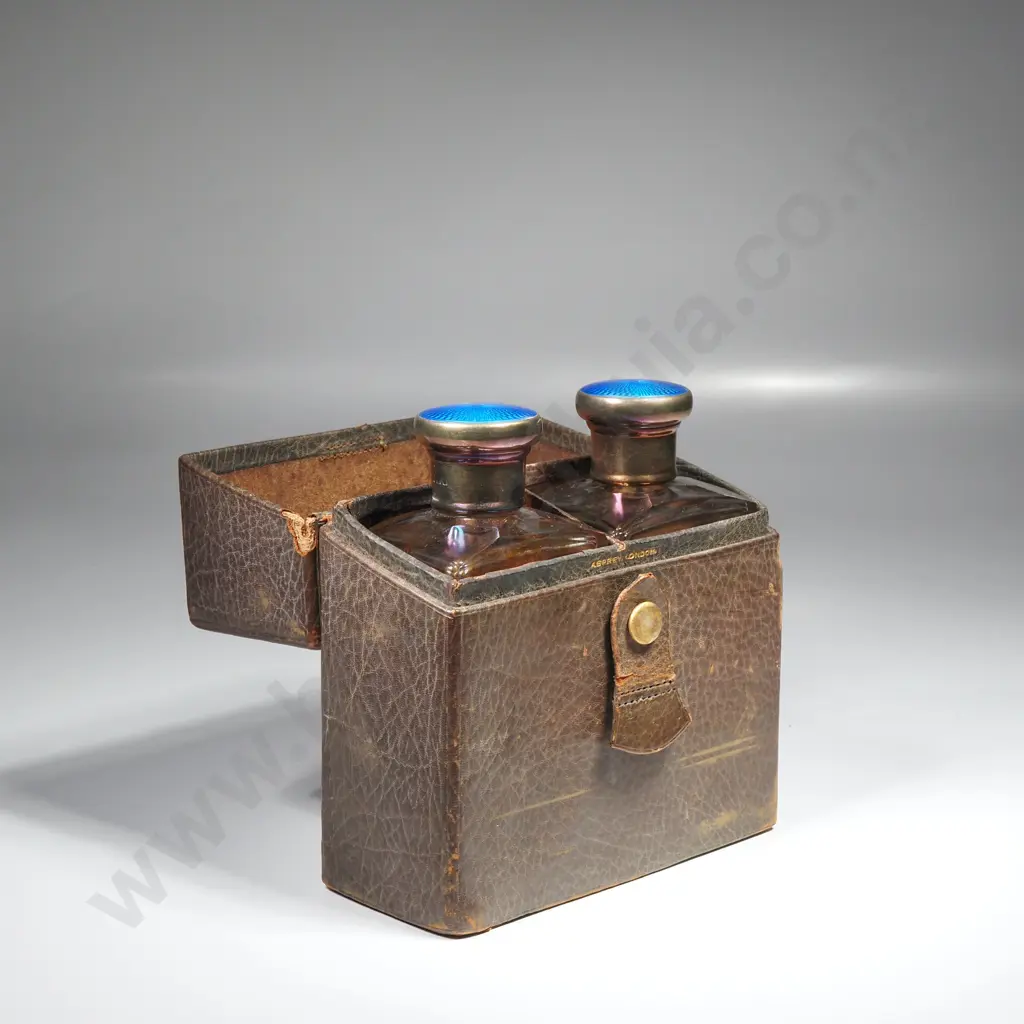 Leather cased pair of glass scent bottles with sterling silver and blue enamel screw on tops, HM London 1928 Image 1++