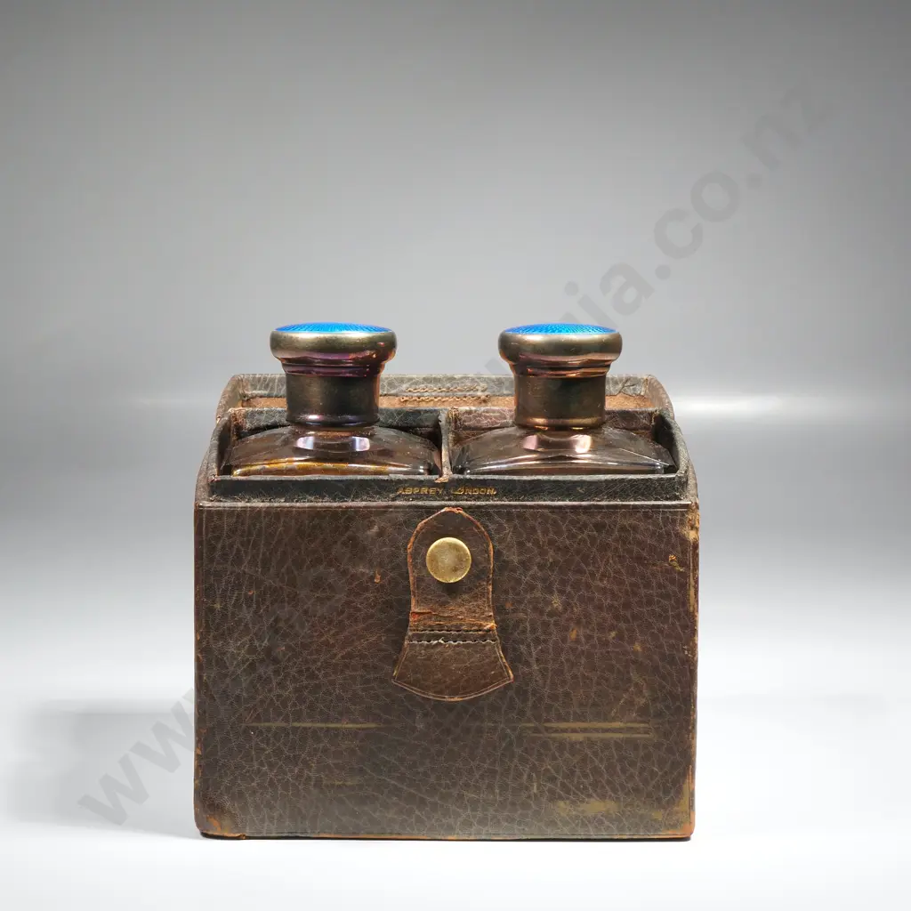 Leather cased pair of glass scent bottles with sterling silver and blue enamel screw on tops, HM London 1928 Image 1++