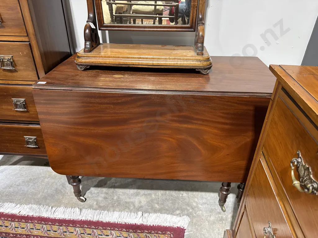 Structure: Features a Central Fixed Top Flanked by Two Hinged Drop Leaves on Turned Legs Terminating in Brass Castors Image 1++