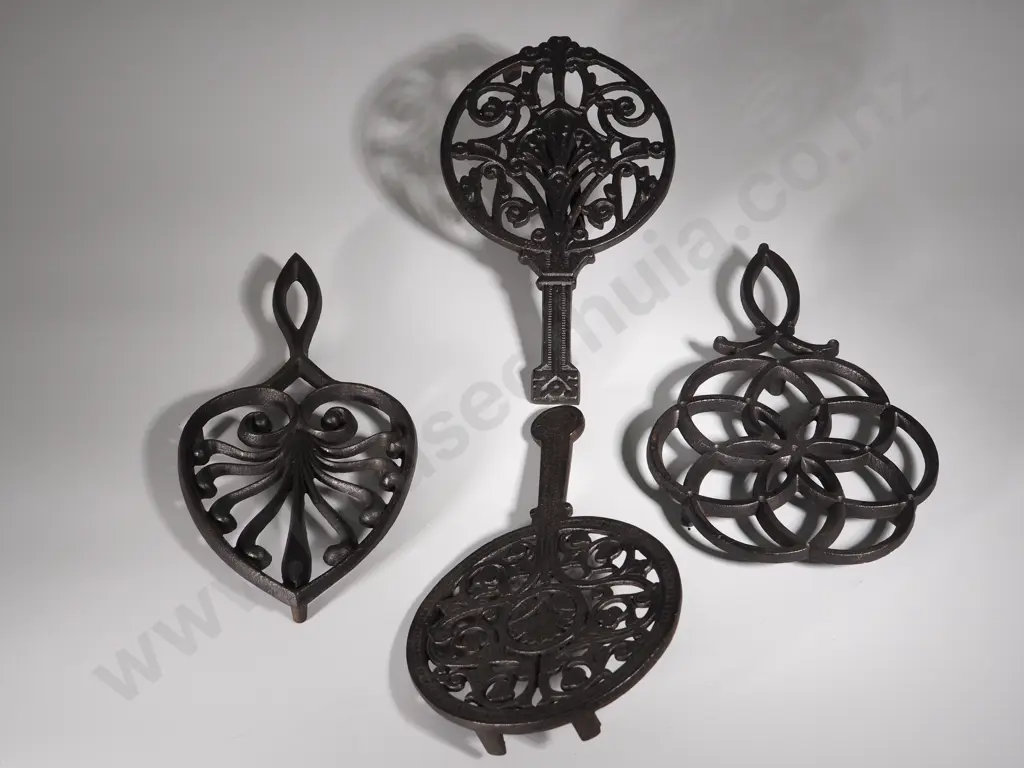 Four Cast Iron Trivets Image 1++
