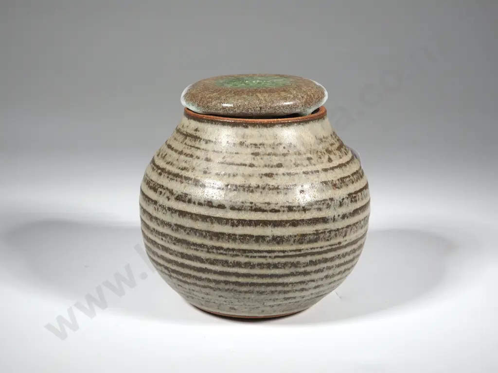 Pottery Lidded Canister - Grey Bisque w Brown Circle Accents Glass around the Canister. Image 1++