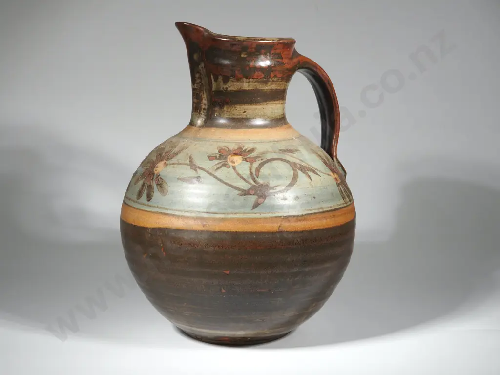 Large Pottery Jug. Possibly Crewanna Pottery (Harry & May Davis).Brown Glazed With Decorative Turquoise Band & Flowers.  Image 1++