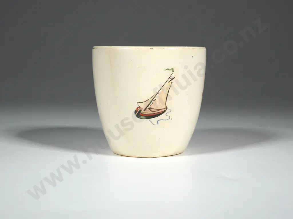 Crown Lynn Egg Cup. White Ground with Bucket & Spade, Ball & Skipping Rope, Yacht. Gold Lettering Crown Lynn Image 1++