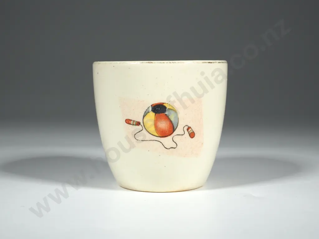 Crown Lynn Egg Cup. White Ground with Bucket & Spade, Ball & Skipping Rope, Yacht. Gold Lettering Crown Lynn Image 1++