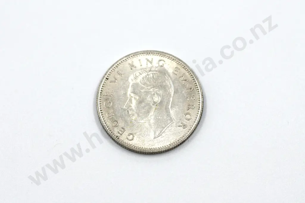 1942 shilling, almost uncirculated with mint lustre, some toning. C.V. $450 Image 1++