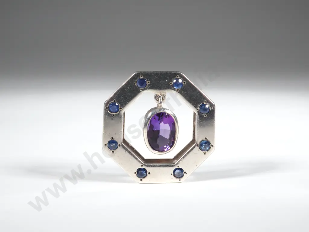 Octagonal Silver Pendant. The Surround Set with Blue Stones & With An Internal Amethyst Coloured Stone Image 1++