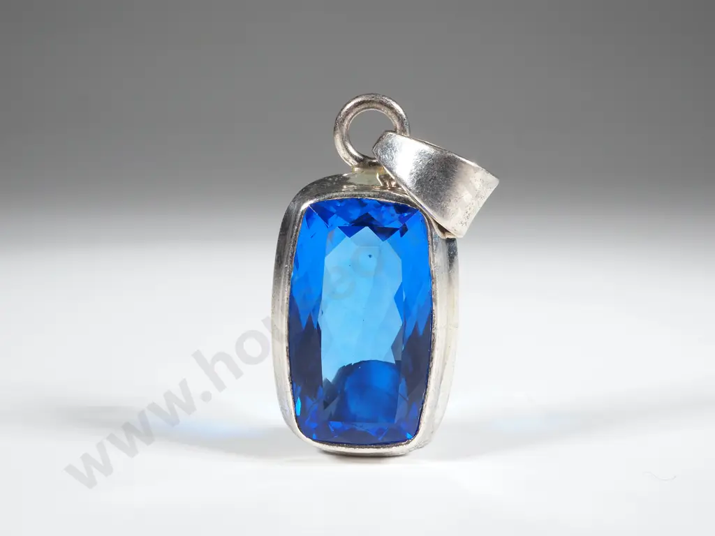 Sapphire Coloured Facetted Pendant In A Sterling Silver Mount  Image 1++