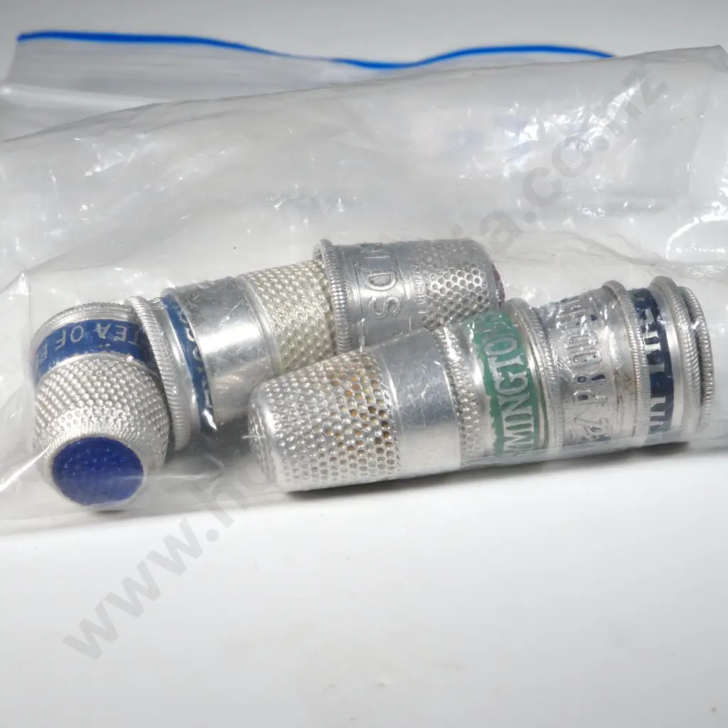 Nine White Metal Advertising Thimbles Image 1++