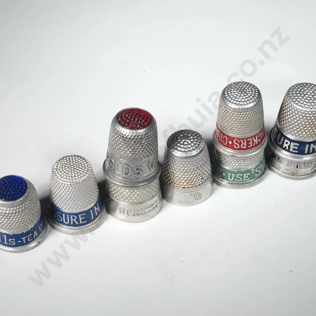 Nine White Metal Advertising Thimbles Image 1++
