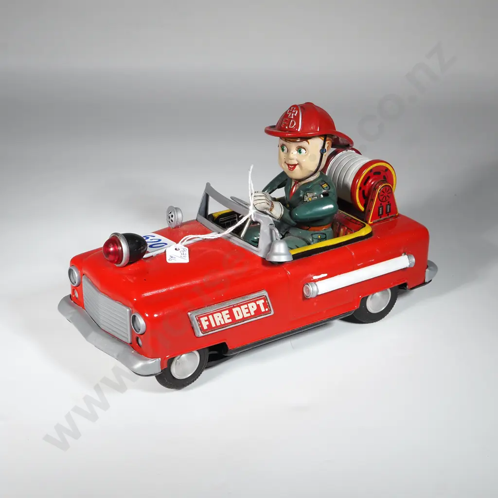 1950s Nomura Tin Red Fire Department Fire truck w Green Driver. Image 1++