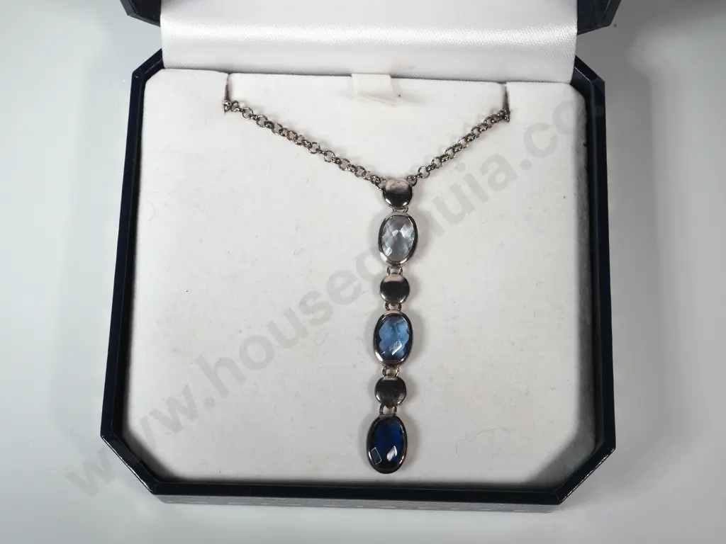Sterling Silver Pendant Necklace.  Pendant - Alternating Dark Blue/Pale Blue Gems and Silver Circles. Image 1++