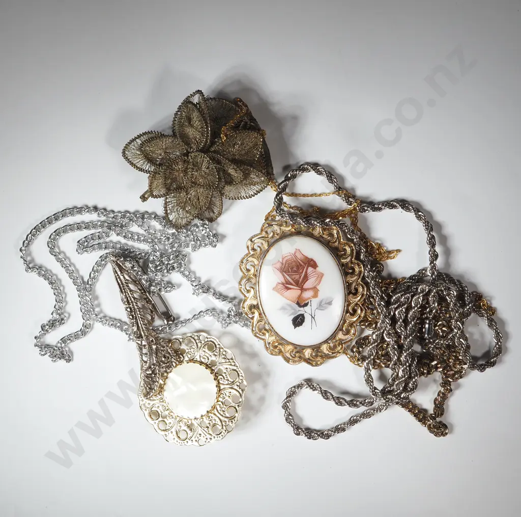 Three Gold Coloured & Three Silver Coloured Chains & Four Brooches. Image 1++