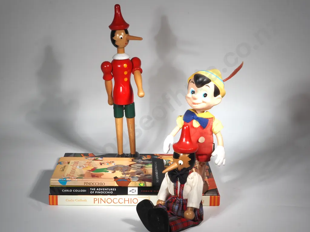 Two Wooden Pinocchio Figures & A Walt Disney Pinocchio Rubber & Plastic Doll & Two Pinocchio Books Image 1++