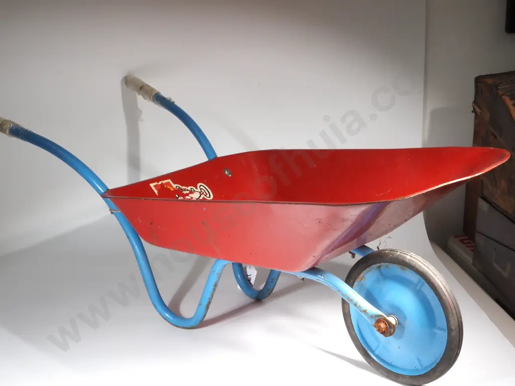 Vintage Metal Child's Wheelbarrow - Red w Blue Handles & Wheels,  Black Rubber Tread & White Handle Grips. Image 1++